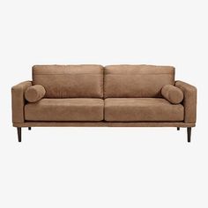 a brown couch sitting on top of a white floor