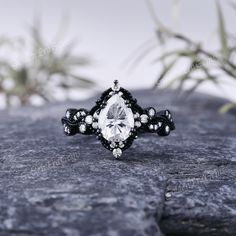 a black and white ring sitting on top of a rock