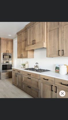 an image of a kitchen setting with wood cabinets and stainless steel appliances on the counter