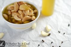 a white bowl filled with nuts next to a yellow drink