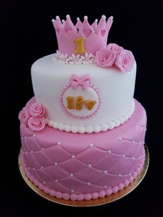 a pink and white cake with a crown on top