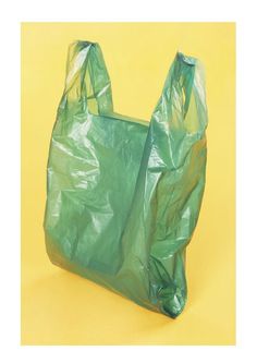 a green plastic bag on a yellow background