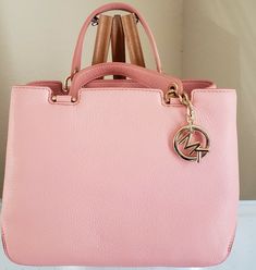 Michael Kors Annabelle Medium Leather Tote Shoulder Bag Authentic & New With Tag Color: Pale Pink The features of this tote include: Made with Michael Kors refined pebble leather Pale pink leather zip pulls Golden tone hardware Top zip closure One zippy pocket and two slip pockets inside Center zip top compartment divide the inside into three compartments Double handle of approximate 4.5" drop Removable and adjustable shoulder strap Come with Michael Kors hanging logo charm, care card and du Luxury Bags Collection, Handbags Fashion, Woman Bags Handbags, Care Card, Pink Leather, Popular Style, Pink Bag, Pale Pink, Pebbled Leather