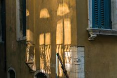 the shadow of a street light on an old building