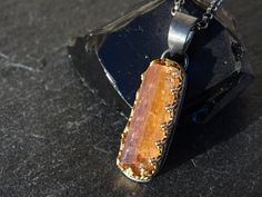 Raw Imperial Topaz crystal pendant, set in 14k gold and black sterling silver. Awesome as a single highlight or layered with other necklaces. Gorgeous gift for your 16th or 23rd wedding anniversary. Topaz is a December birthstone. > overall 33.5mm (1.31 inches) long Topaz pendant incl. the bail > 100% hand crafted from 14k yellow gold and sterling silver > genuine uncut Imperial Topaz gemstone crystal > black sterling silver necklace in the length of your choice The rough gemstone is an uncut, u Amber Faceted Pendant Jewelry, Faceted Topaz Jewelry As A Gift, Topaz Pendant Necklace As A Gift, Topaz Pendant Necklace For Gifting, Topaz Pendant Jewelry As A Gift, Unique Handmade Topaz Jewelry, Minimalist Topaz Jewelry As A Gift, Faceted Citrine Pendant Jewelry, Fusion Style Faceted Necklace For Gift