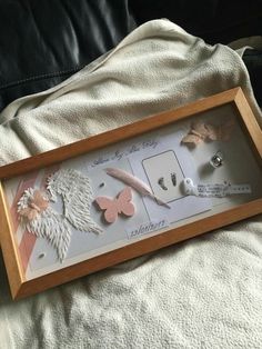 a wooden frame with some pink and white items in it