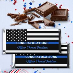 chocolate bar wrappers with an american flag design and congratulationss written in blue on them