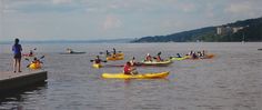 several people in kayaks paddling on the water