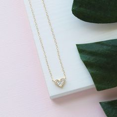 Our Gold Heart Necklace is so dainty & feminine! This cubic zirconia necklace sparkles just like a real diamond! It makes for the perfect gift to give a loved one as it is so simple and elegant. ---------------------- FEATURES ◊ Cubic Zirconia gold heart charm ◊ 14K gold filled chain ◊ All necklace findings (clasp, jump rings, tag) are 14K gold filled to ensure the highest quality piece ◊ Model is wearing the 17 inch length ---------------------- PACKAGING ◊ We do the gift-wrapping for you! Wedding Heart Necklace With Diamond Accents For Valentine's Day, Valentine's Day Wedding Heart Necklace With Diamond Accents, Cubic Zirconia Solitaire Necklace For Valentine's Day Wedding, Wedding Necklace With Heart Charm And Cubic Zirconia, Wedding Cubic Zirconia Necklace With Heart Charm, Wedding Heart Necklace In Diamond White Cubic Zirconia, Cubic Zirconia Heart Necklace With Diamond Accents For Wedding, Valentine's Day Wedding Diamond Heart Necklace, Mother's Day Dainty Diamond Accent Necklaces