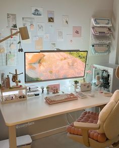 a desk with a computer, keyboard and chair in front of it on top of a white table