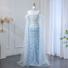 Feel like royalty in our Dreamy Vow Luxury Arabic Light Blue Mermaid Evening Dress. With its elegant high neck and stunning cape sleeves, this dress will make you the star of any wedding party. The mermaid silhouette accentuates your curves while the light blue color adds a touch of dreamy charm. SS096. window.adminAccountId=244214477; Blue Cape Dress For Party, Blue Wedding Gown With Cape Sleeves, Blue Gown With Cape Sleeves For Party, Evening Gown With Cape, Blue Mermaid Gown, Gown With Cape, Cape Sleeve Dress, Mermaid Evening Gown, Prom Dresses For Sale