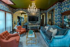 a living room filled with furniture and a chandelier