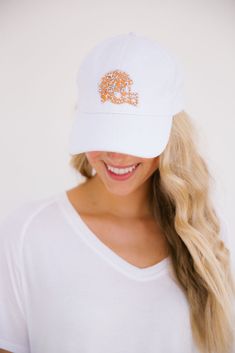 Cheer on your favorite football star in this cute hat! This hat is perfect for the beach, gym, a hike, or just to cover up a bad hair day. We won't judge. White Sports Fan Hat, One Size Fits Most, White Sports Fan Hat One Size Fits Most, Adjustable Hats For Sports Events, Adjustable White Hat For Game Day, Trendy White Hat For Sports Events, Gold Helmet, Style Ponytail, Beach Gym, Coral Navy