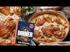 the dinner cookbook is next to a pan full of chicken and sauces on a table