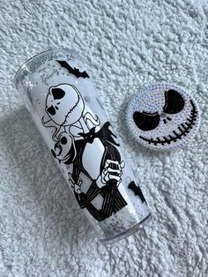 the tumbler cup is decorated with an image of skeleton and jack - o'- lantern