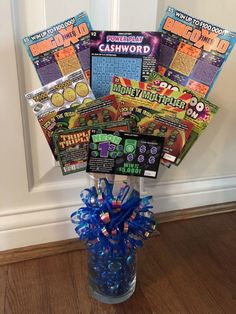 a vase filled with candy and magazines on top of a wooden floor