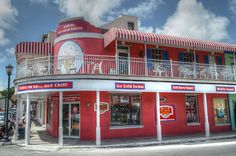 a red building with white balconies on the top