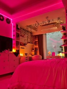 a bedroom with pink lighting and decorations on the walls, along with a bed in front of a window