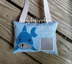 a small blue bag with a shark on it and the words shark toth