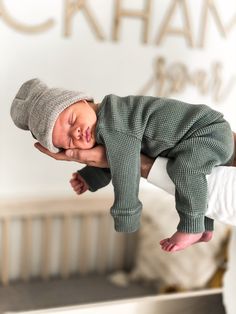 a baby is being held up in the air