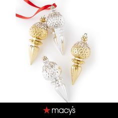 three gold and silver christmas ornaments hanging from a red ribbon on a white background with the words macy's written below it