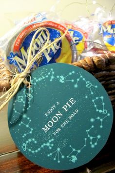 a basket filled with cookies and snacks on top of a wooden table next to a sign that says moon rise