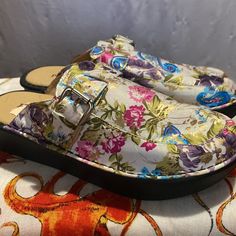 These Floral Clogs Or Slides Remind Me Of A Well Tended Garden!! They’re Just Beautiful They Do Have A Buckle Across The Top Of Them I Guess You Could Take Them Up On The Sides If You Needed To And They Are Made Of A Hard Rubber But The Inside Is Cushy. Somebody Put A Tag In The Shoe And When I Took It Off To Take This Picture They Top Of The End So I Don’t Know Covering Came Off But It’s Nothing To Crop Out Really. Your Foot Would Always Be Over It These Are Brand New Never Worn Multicolor Slip-on Clogs For Spring, Spring Multicolor Clogs With Cushioned Footbed, Spring Multicolor Flat Clogs, Just Beautiful, A Well, Over It, I Don T Know, Mule Clogs, Mules Shoes