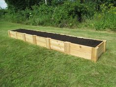 a large wooden garden box filled with dirt