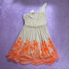 Nude Dress With Bright Orange Embroidery, Never Worn. One Shoulder Side Zipper Closure Skirt Has Just The Right Amount Of Fluff And Swing! Fabric Feels Light, Airy, Soft, And Elegant Has Belt Loops But No Belt Included Very Unique And Showstopping Art Deco Avant Garde Hits At/Above Knee Depending On Height (1-2in Above Knee For Me: 5’0”) Juniors Size 7, Could Fit Women’s Small/Medium Measurements: Pit To Pit: 14in Shoulder To Hem: 33-34in Offers And Bundles Welcome! Spring One-shoulder Lined Dress, Orange A-line Summer Dress, Apricot Summer Party Dress, Apricot Sleeveless Spring Dresses, Lined Orange Mini Dress For Summer, Orange Lined Mini Dress For Summer, Apricot Mini Dress For Summer Party, Casual Apricot Dress For Party, Sleeveless Orange Spring Dresses