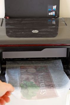 a person is pressing the print out of a printer