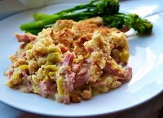 a white plate topped with meat and veggies