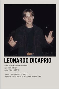 a man standing in front of a poster with his hands out and the words leonardo dicaprio on it