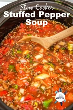 slow cooker stuffed pepper soup in a crock pot with a wooden spoon on top