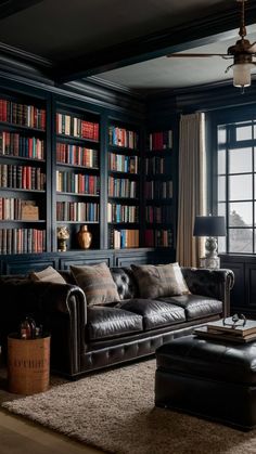 a living room filled with furniture and bookshelves covered in lots of bookcases