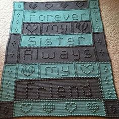 there is a crocheted blanket on the floor with words written in different languages