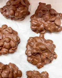 chocolate covered cookies sitting on top of white paper