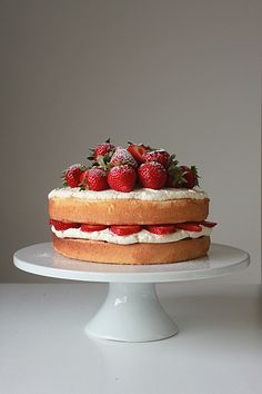 a cake with strawberries on top is sitting on a plate