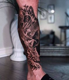 a man's leg with a tattoo on it and an eagle in the middle