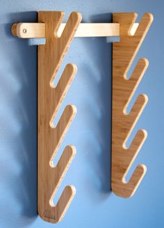 two wooden pegs are hanging on the wall