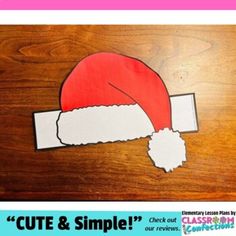 a santa hat cut out on top of a wooden table with the text cut & simple