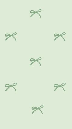 a green wallpaper with small bows on it