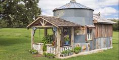 the country living website has an image of a small blue house with potted plants on it