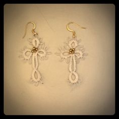 two pairs of earrings with white crochet on them