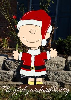 a cartoon character is standing in the grass with his hands out and wearing a santa hat