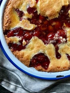 a close up of a pie in a bowl on a table with a napkin and fork