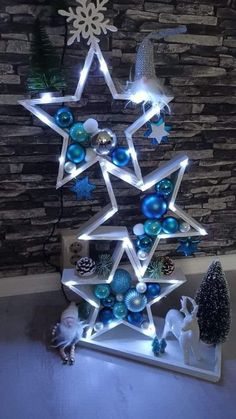 a lighted christmas tree with blue and white ornaments