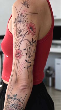 a woman's arm with flowers and lines on the back of her body,