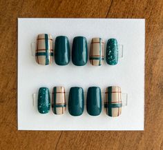 Plaid is almost a staple of fall manicures and this set combines a lovely dark teal color with glitter and plaid for the perfect fall or winter mani. Shown on short squares.  Each set comes with nail glue, a mini buffer block, a cuticle pusher and an alcohol wipe for optimal prep before applying the nails. All products used are Beetles gel polish brand. Avoid inhalation, ingestion, and eye contact. If irritation or allergic signs occurs, stop use immediately. If signs persist, seek medical attention. Keep out of reach of children. Refer to Beetles' products for further product information and ingredients. Teal Plaid Nails, Transition Nails Fall To Winter, Winter Plaid Nail Designs, Fall Nails Turquoise, Fall Plaid Nails Short, Navy Plaid Nails, Flannel Nails Fall, Fall Nails With Plaid, Turquoise Fall Nails