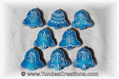 blue decorated cookies are arranged in the shape of christmas trees