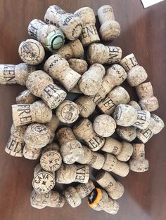 a pile of wine corks sitting on top of a wooden table